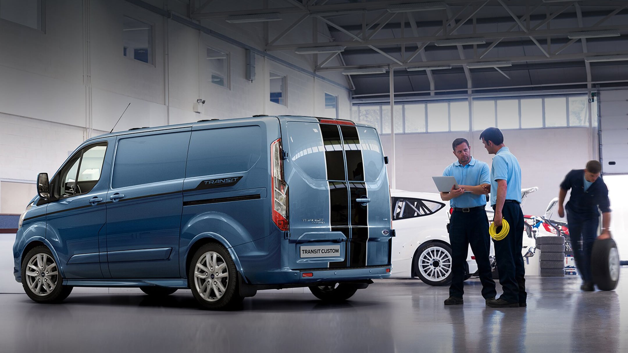 Ford Transit Custom being inspected by maintenance crew